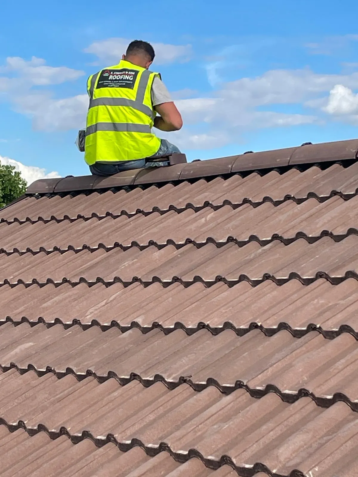 One of the team fitting ridge tiles on a new roof